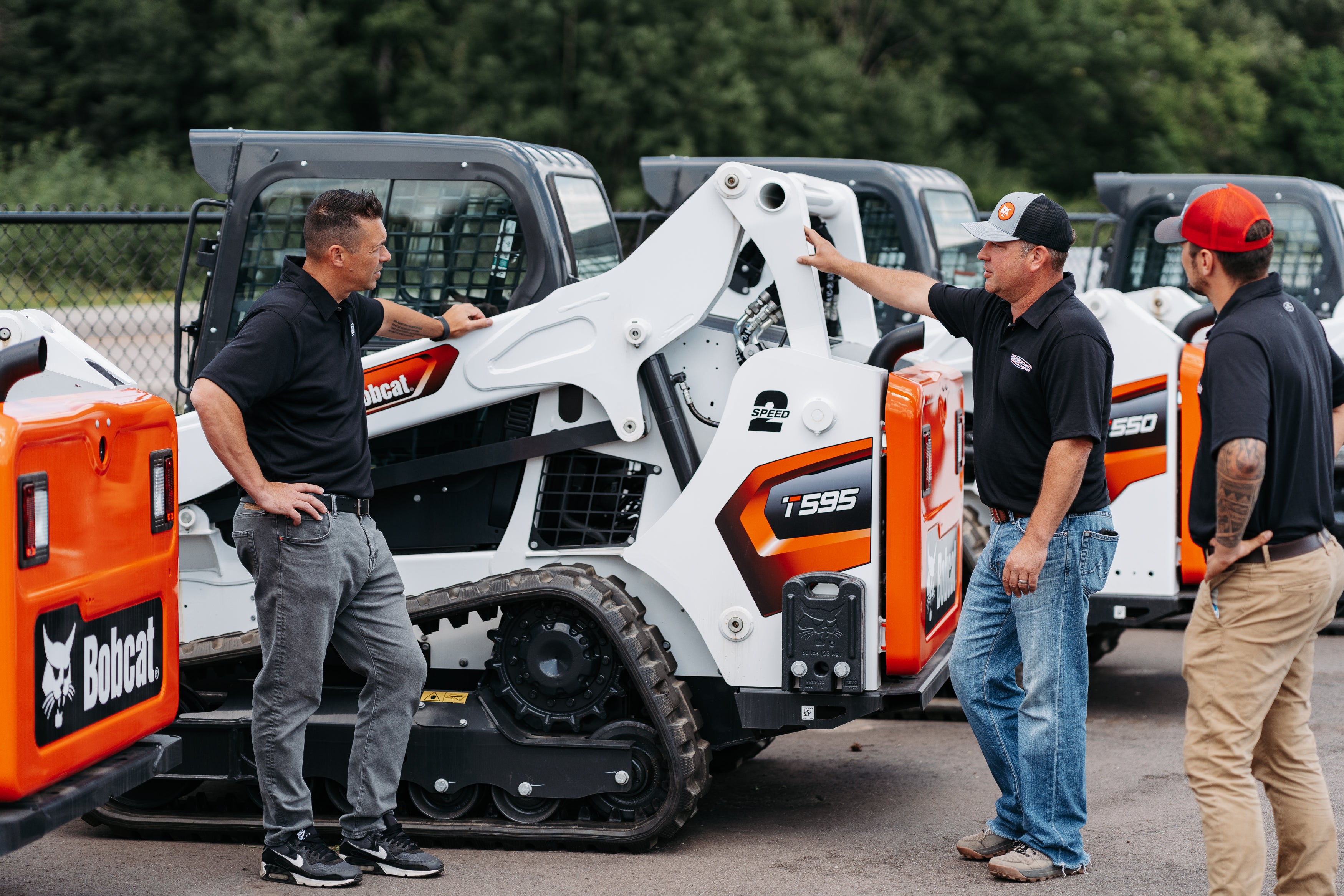 tri-state bobcat employees working around a bobcat track loader